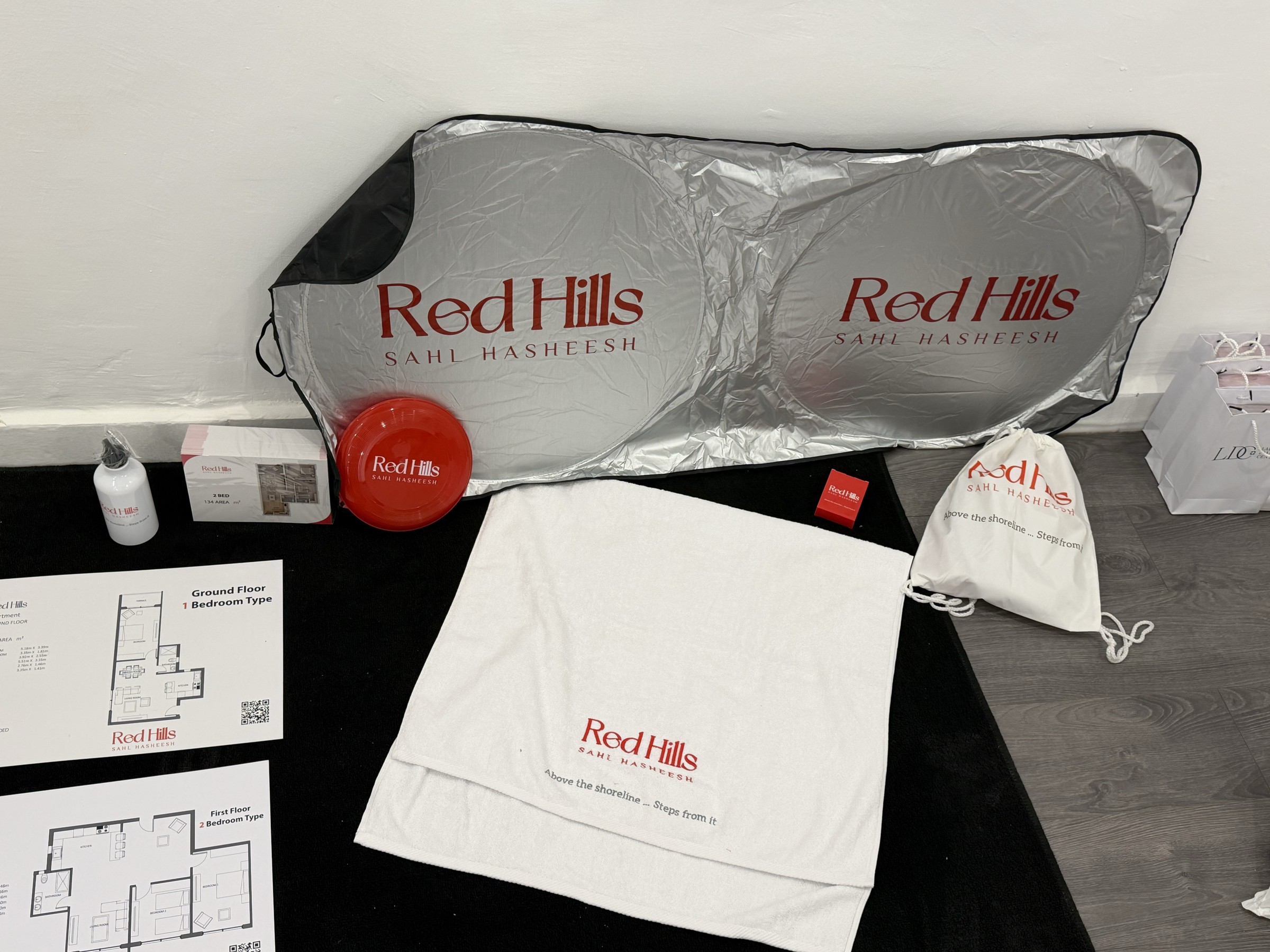 Red Hills branded sunshade, towel, bag, bottle, flying disc and printed project materials