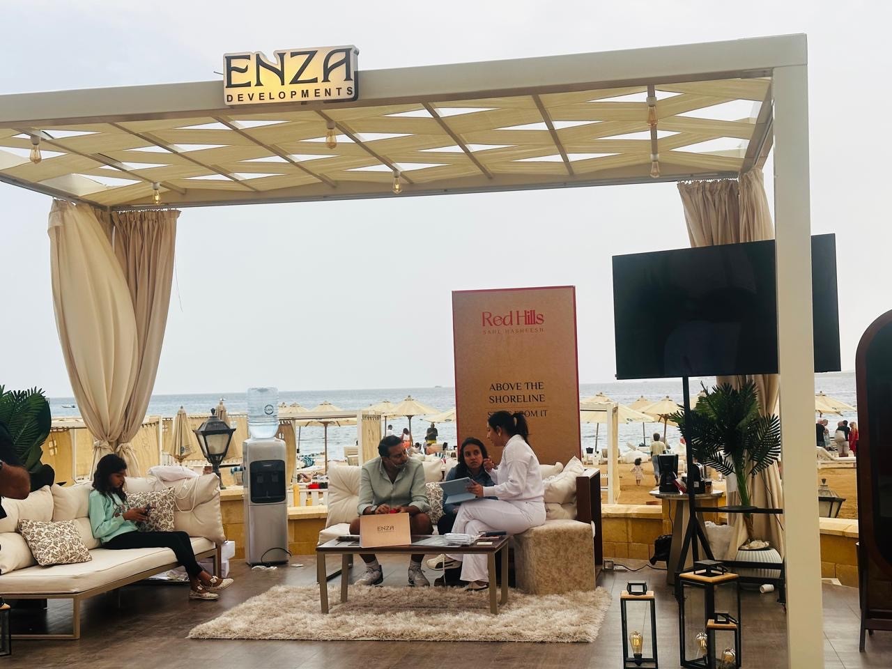 Guests seated in the ENZA Red Hills branded beachfront lounge